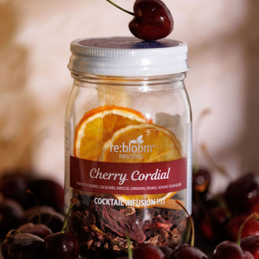 Cherry cordial cocktail infusion kit with dried cherries and citrus slices in glass jar by Rebloom Infusions