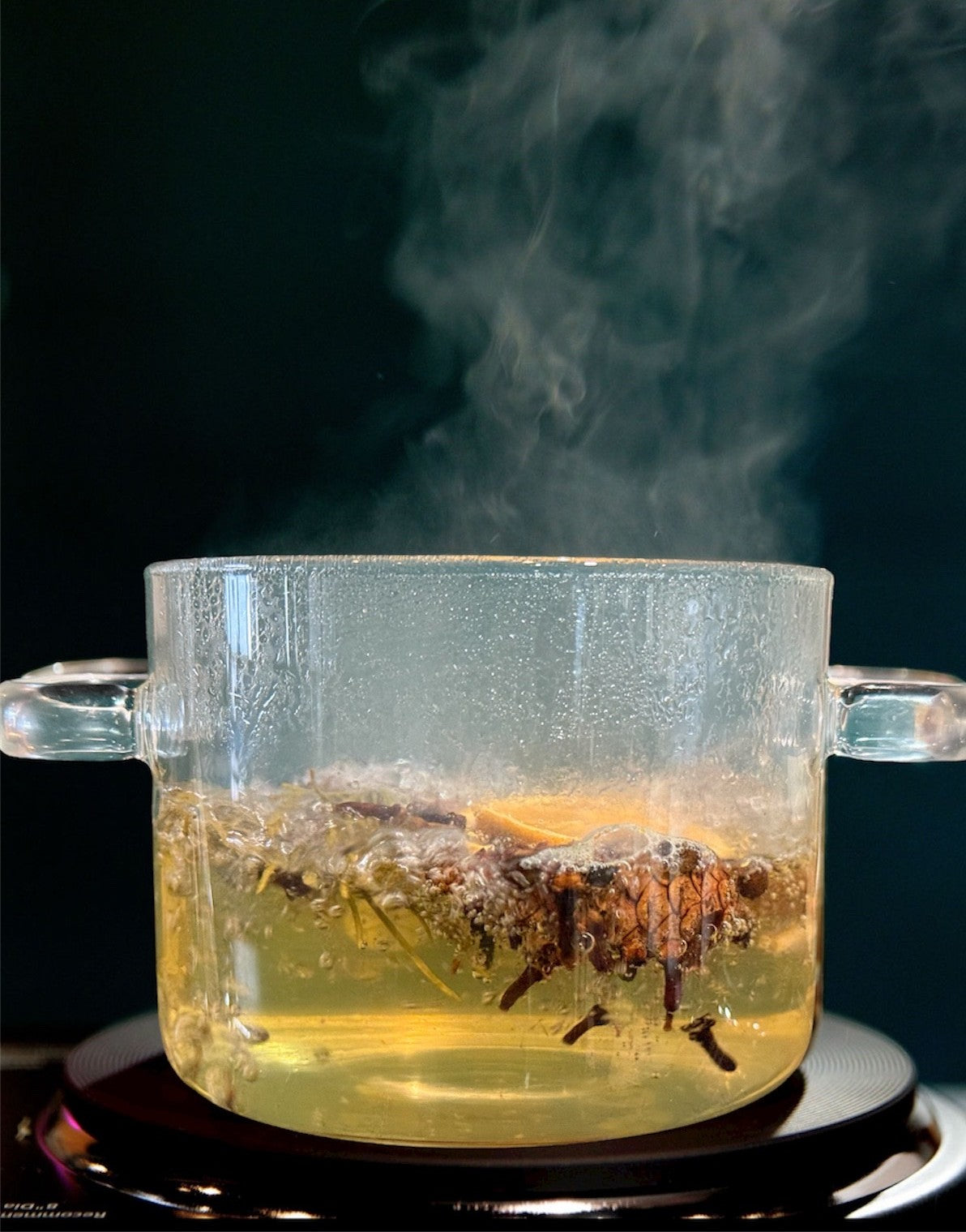 Glass simmer pot with christmas fragrance of evergreen pine.