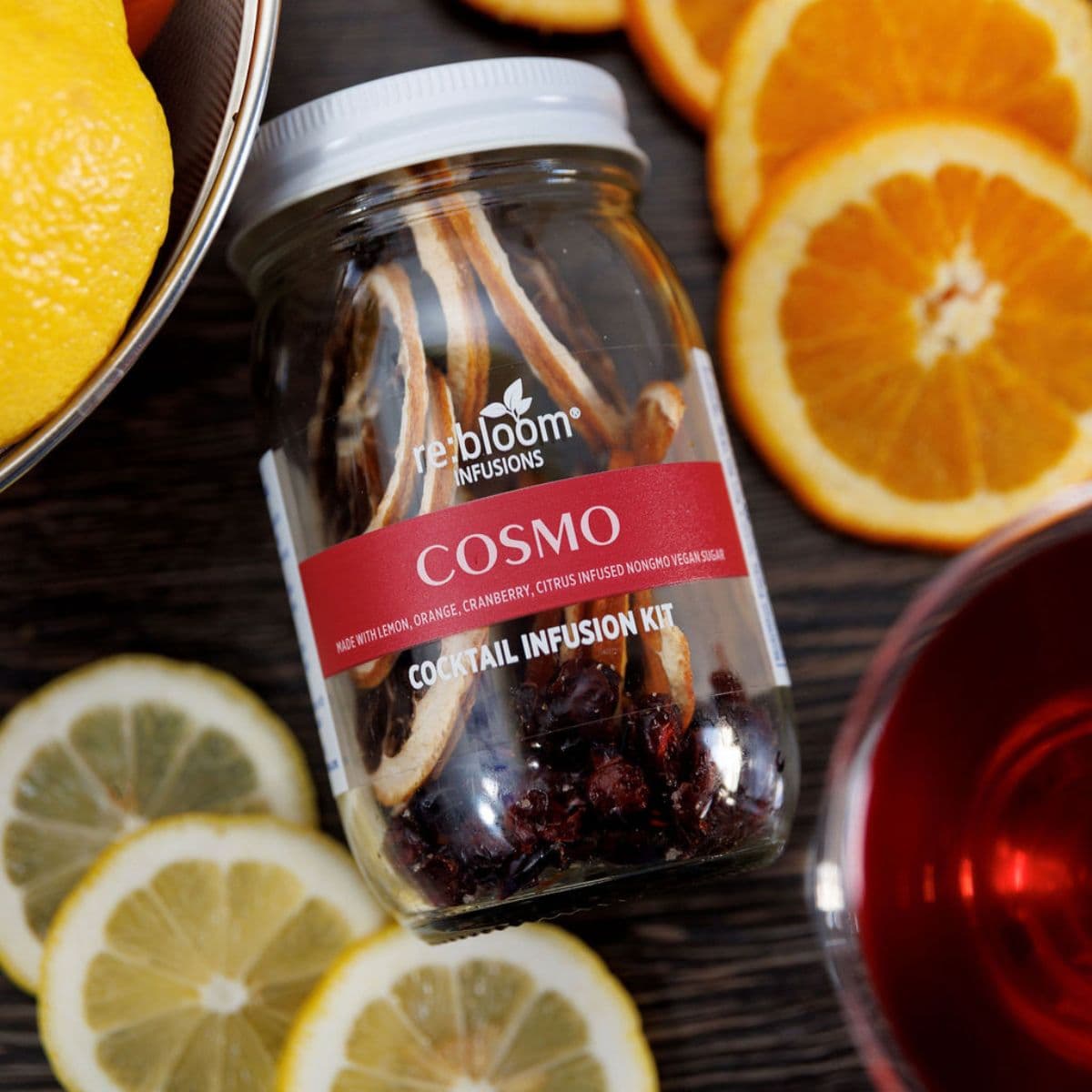Cosmo cocktail infusion kit jar with dried fruit, lemon and orange slices.