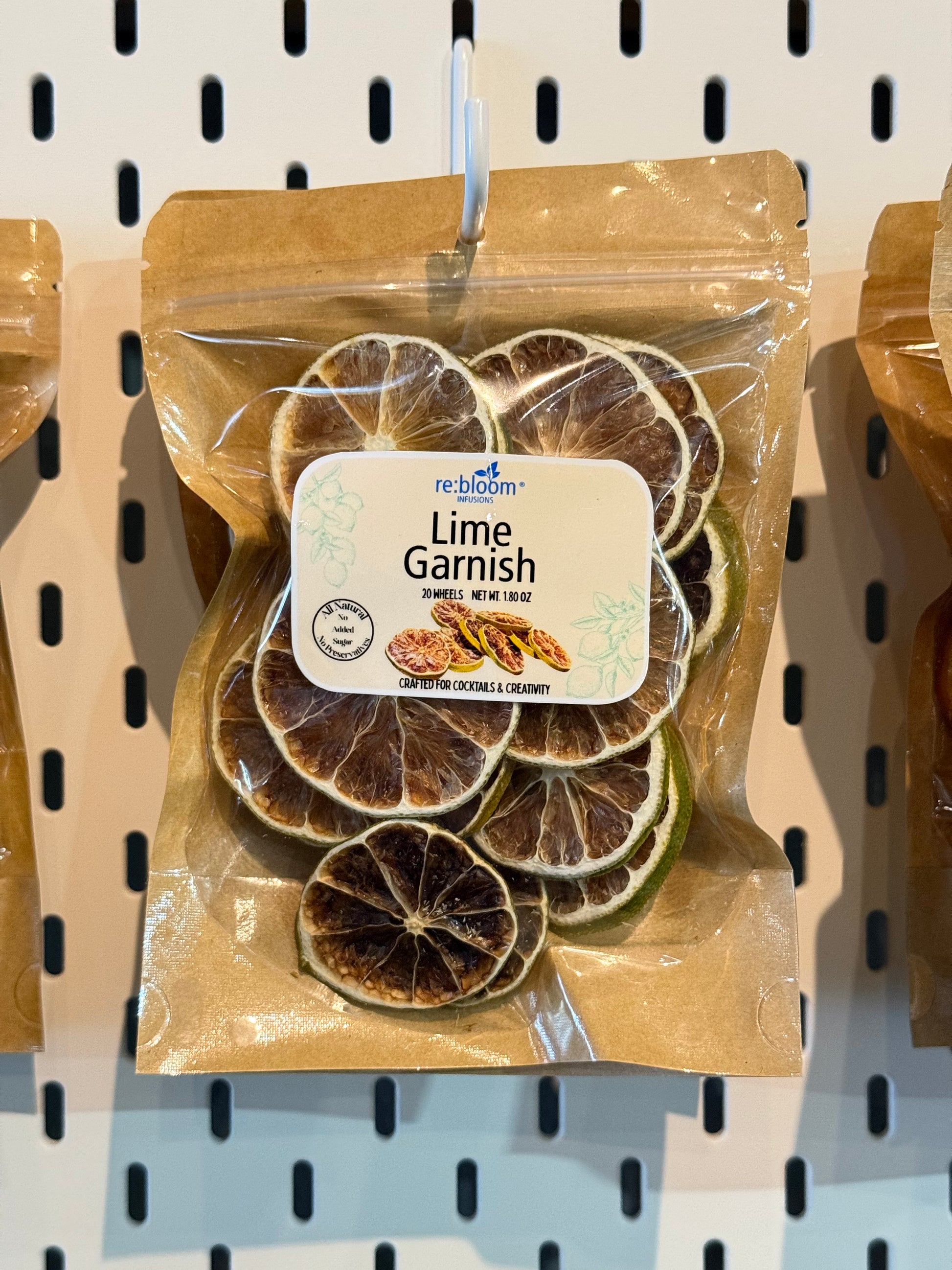 Packaged lime garnish hanging on a peg board
