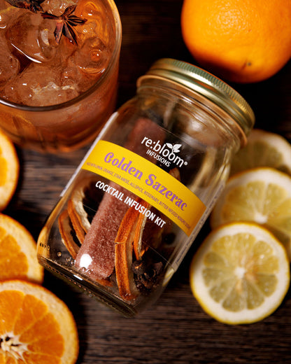 Golden Sazerac kit Infusion surrounded by fresh citrus on a wooden background