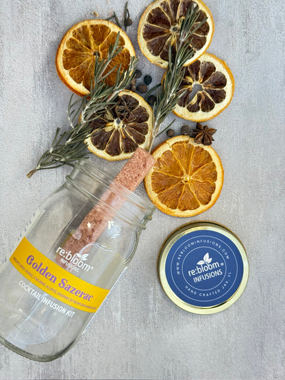 Jar of Golden Sazerac spice mix with dried citrus slices and rosemary on a gray surface