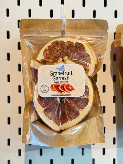 Packaged dried grapefruit slices with a visible brand label on a peg board.
