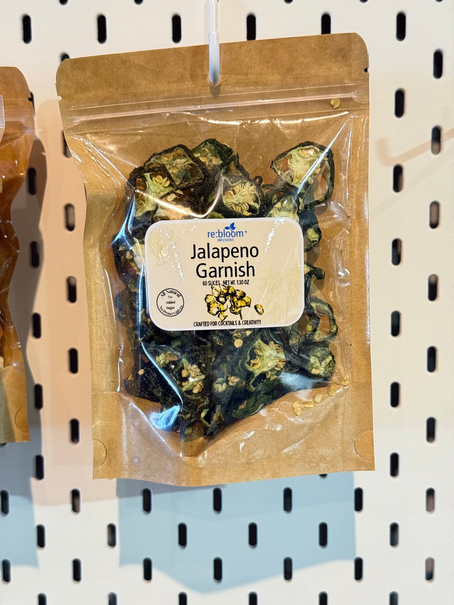 Packaged jalapeno garnish on a pegboard