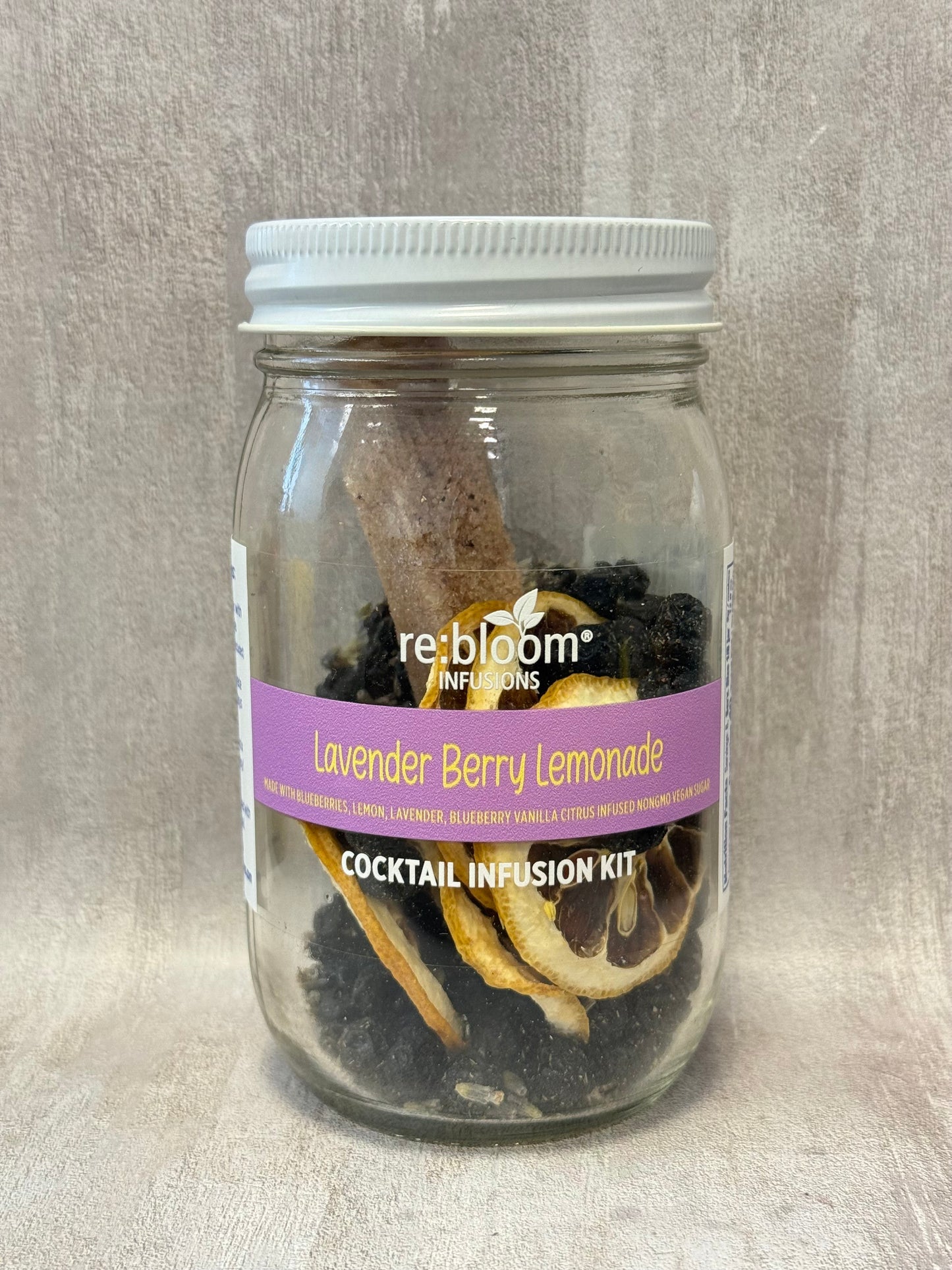 Jar of Lavender Berry Lemonade cocktail infusion kit with a visible label on a neutral background