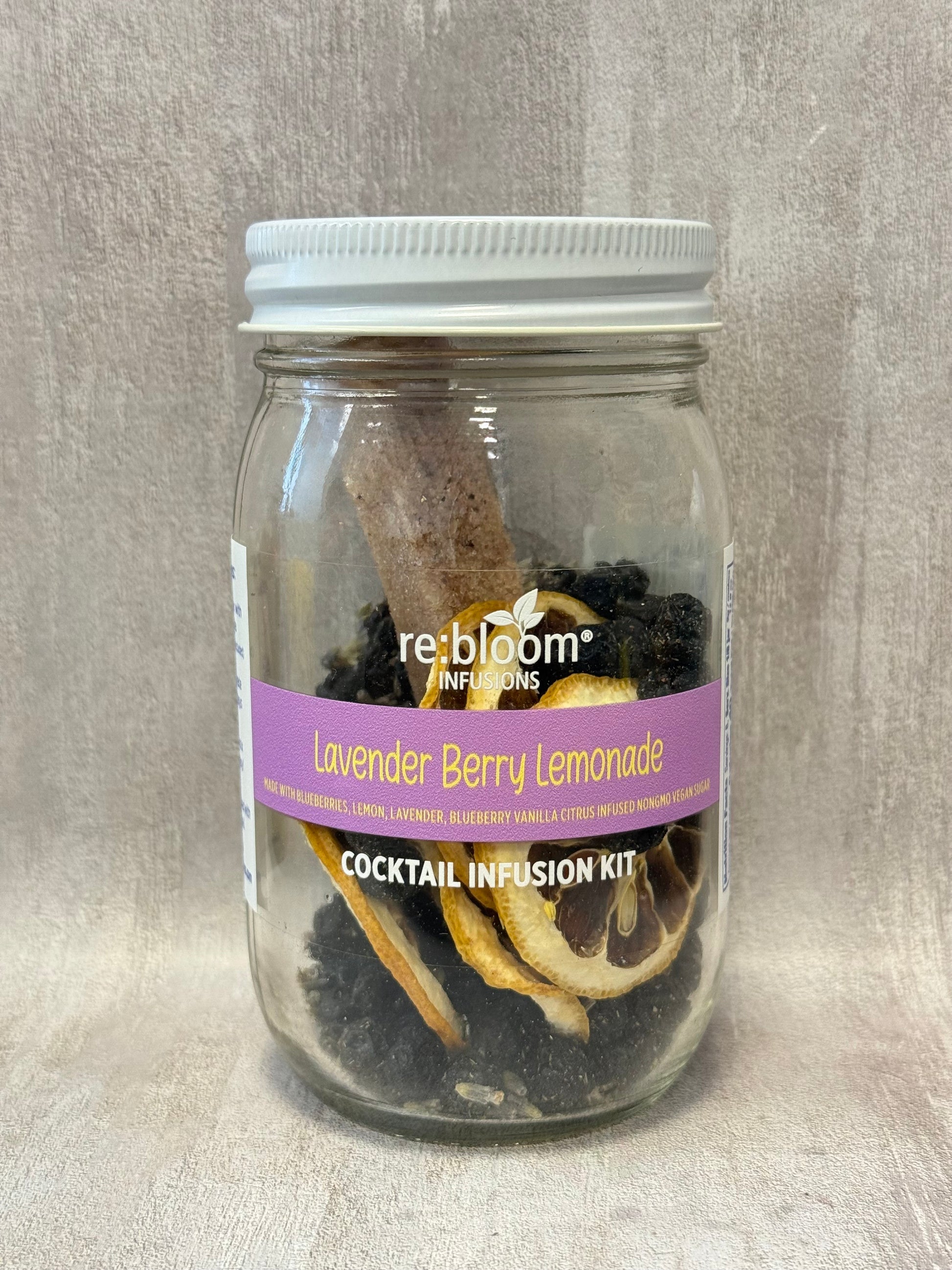 Jar of Lavender Berry Lemonade cocktail infusion kit with a visible label on a neutral background