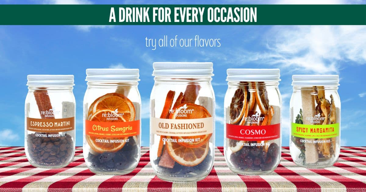 Five clear glass jars of flavored dried fruit mixtures arranged on a red-and-white checkered picnic blanket against a blue sky background. A green banner at the top reads 'A DRINK FOR EVERY OCCASION' with smaller text 'try all of our flavors.
