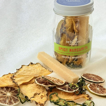 Spicy Margarita cocktail infusion kit with dried fruits and a rolling pin on a light background