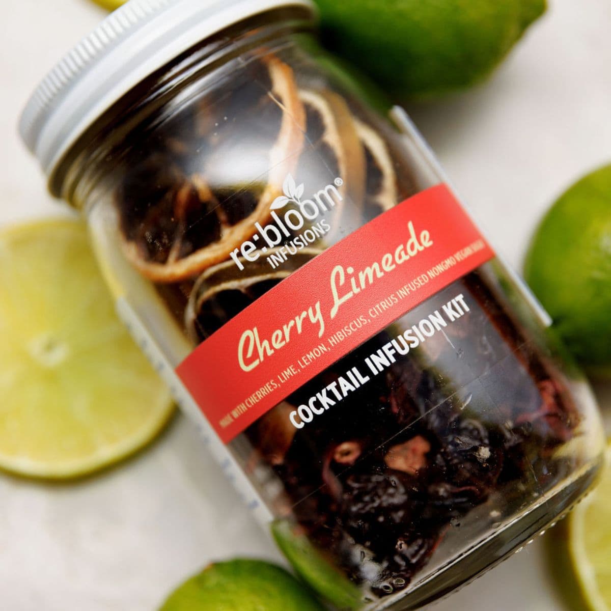 Cherry limeade cocktail infusion kit with lime, lemon, and dried cherries in glass jar by Rebloom Infusions