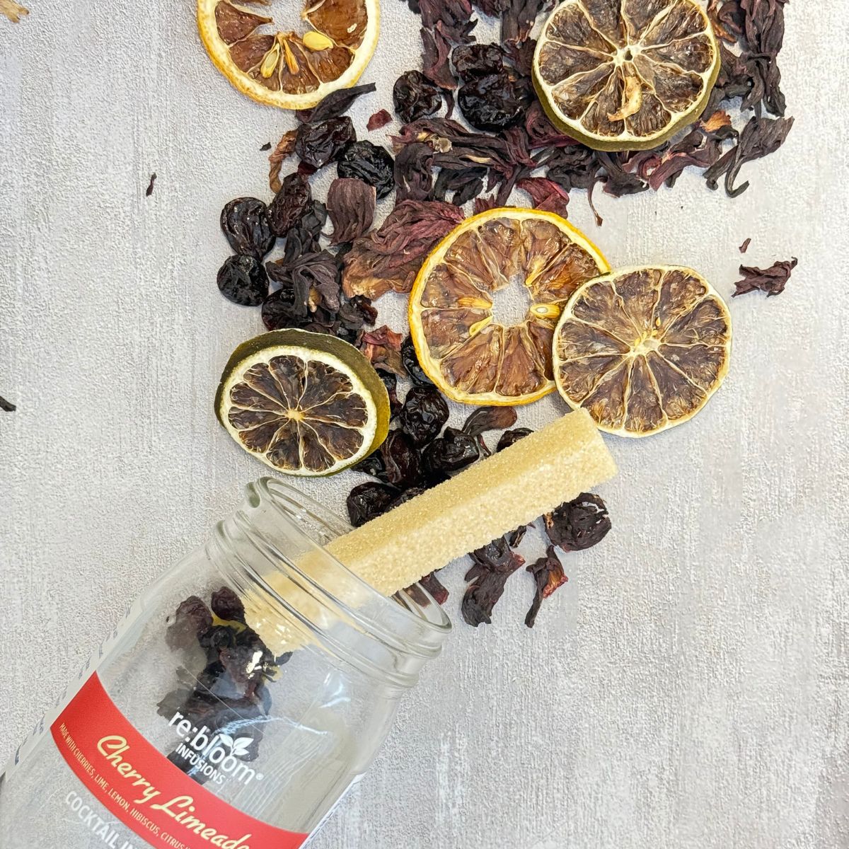 Cherry limeade infusion kit ingredients with dried lime, lemon, cherries, and hibiscus by Rebloom Infusions
