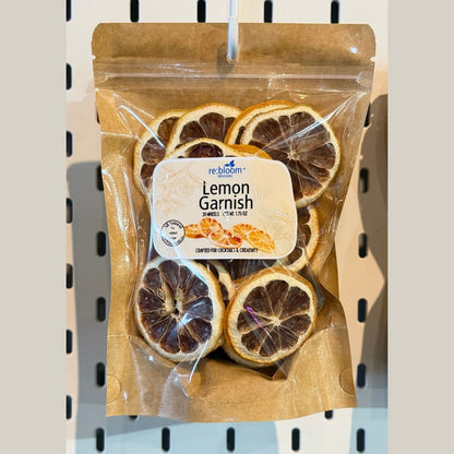 Dehydrated lemon garnish slices packaged for cocktails and mocktails displayed on a pegboard