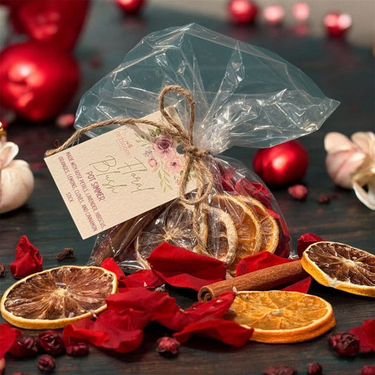 Floral blush simmer pot blend with dried orange slices, cinnamon sticks, and rose petals in gift bag