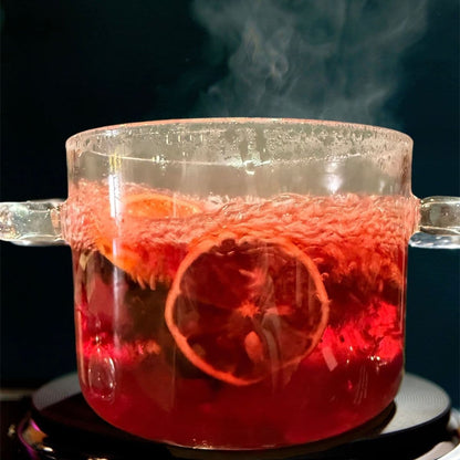 Floral blush simmer pot blend brewing on stovetop with dried orange slices and spices in glass pot