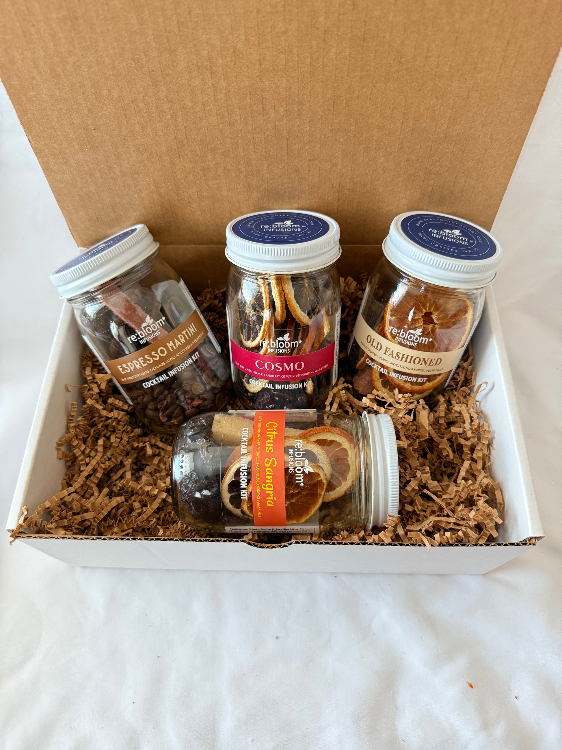 Assorted cocktail infusion jars in a white gift box