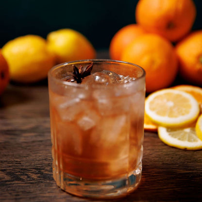 Golden Sazerac cocktail with star anise garnish, citrus, and ice in rocks glass made from infusion kit