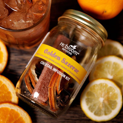 Golden Sazerac cocktail infusion kit with prepared drink, orange slices, lemon, and spices by Rebloom Infusions