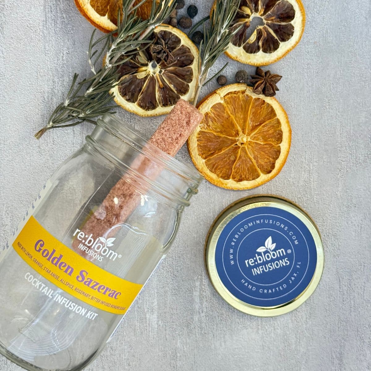 Golden Sazerac infusion kit ingredients with dried orange slices, lemon, rosemary, and spices by Rebloom Infusions