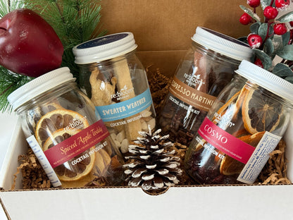 Jars of cocktail infusion kits in a gift box decorated for christmas