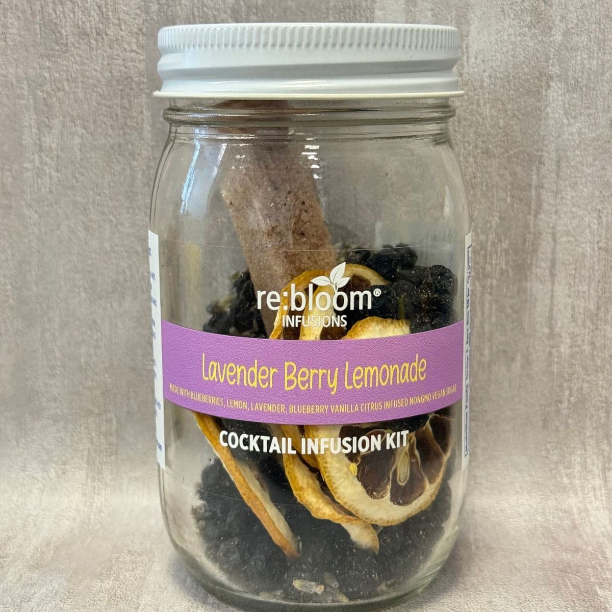 Lavender berry lemonade cocktail infusion kit in glass jar with dried lemon slices and blueberries by Rebloom Infusions