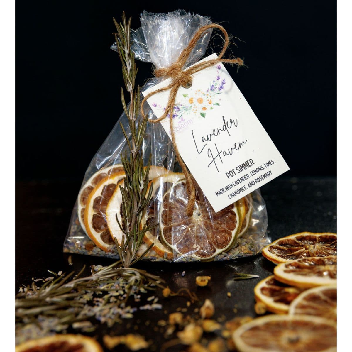 Lavender Haven simmer pot kit with dried citrus slices, lavender, chamomile, and rosemary in a gift bag.