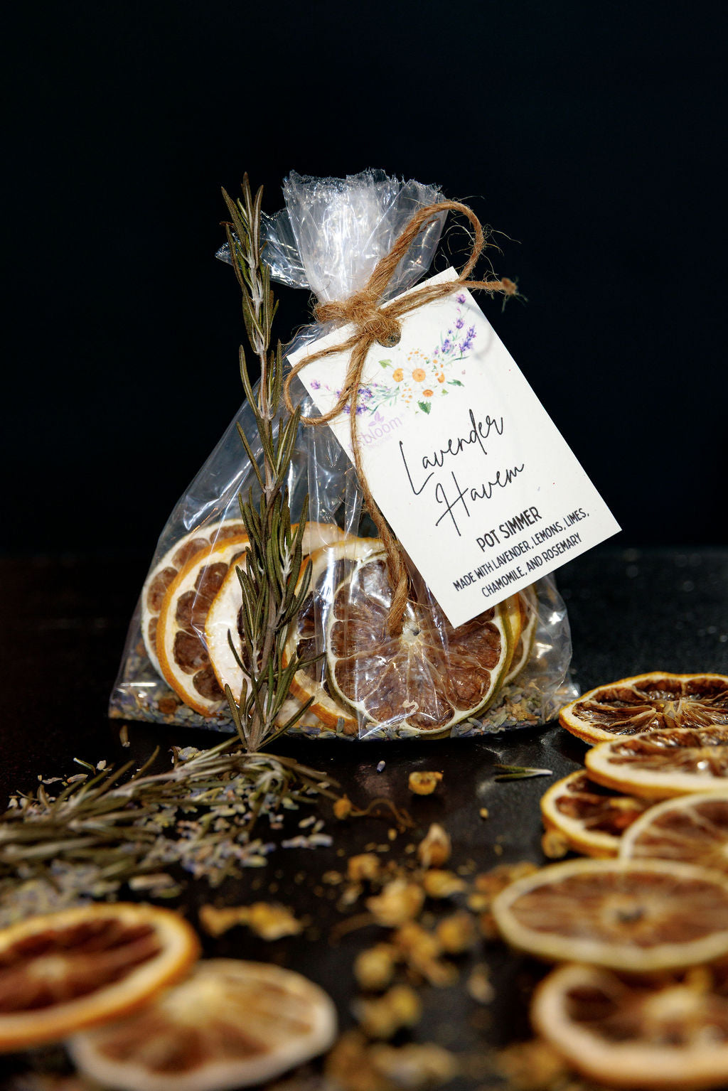 Simmer pot kit made of lavender, chamomile and citrus slices with a label on a dark background