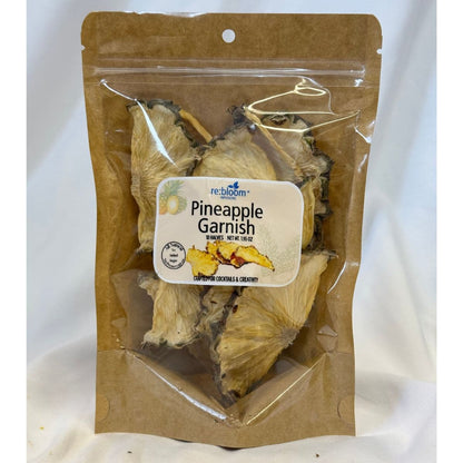Packaged dried pineapple garnish with visible re:bloom Infusions label on a white background.