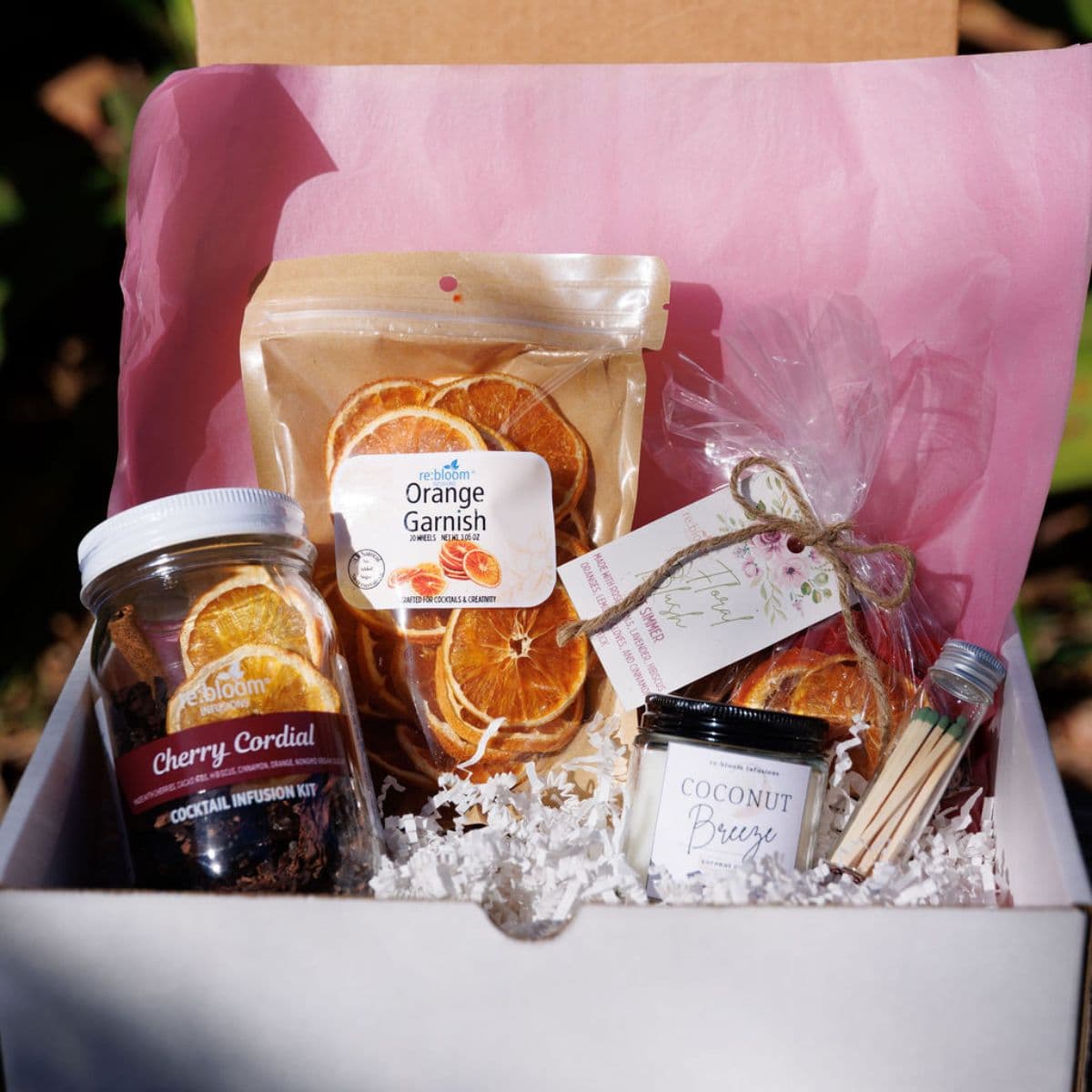 Valentine’s cocktail infusion gift box with dried orange garnish, cherry cordial infusion kit, and cocktail accessories by Rebloom Infusions
