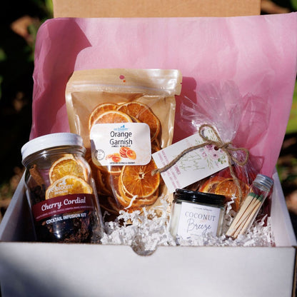 Valentine’s cocktail infusion gift box with dried orange garnish, cherry cordial infusion kit, and cocktail accessories by Rebloom Infusions