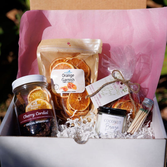 Valentine’s cocktail infusion gift box with dried orange garnish, cherry cordial infusion kit, and cocktail accessories by Rebloom Infusions